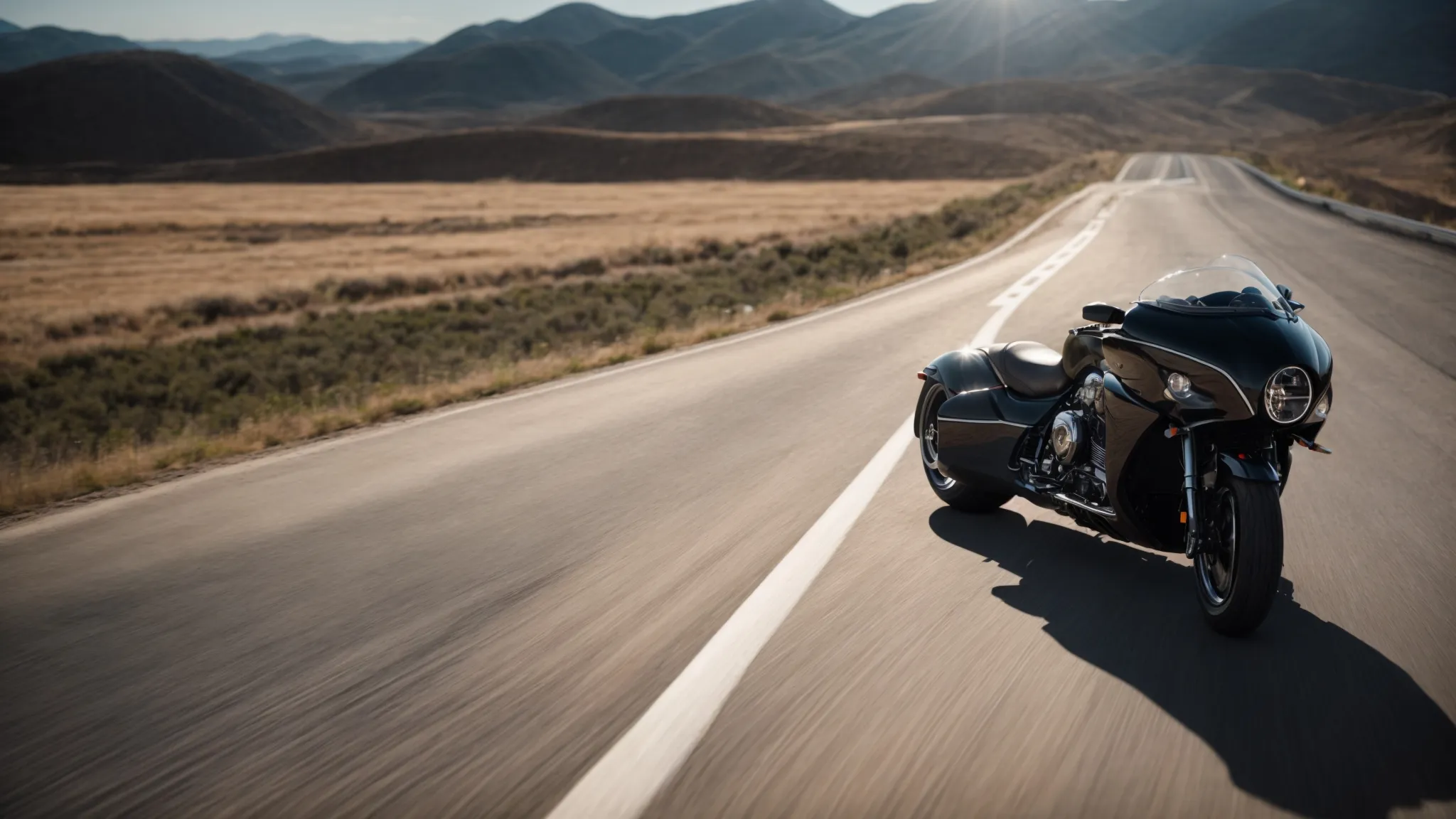 a sleek motorcycle is carefully guided into an enclosed trailer against a backdrop of an open road stretching towards the horizon.