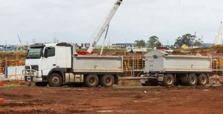 a white truck with a crane on top of it