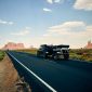 black vehicle towing trailer on black road during daytime